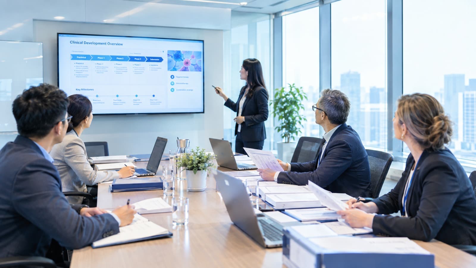 A clinical development team reviewing a Clinical Development Overview presentation in a boardroom
